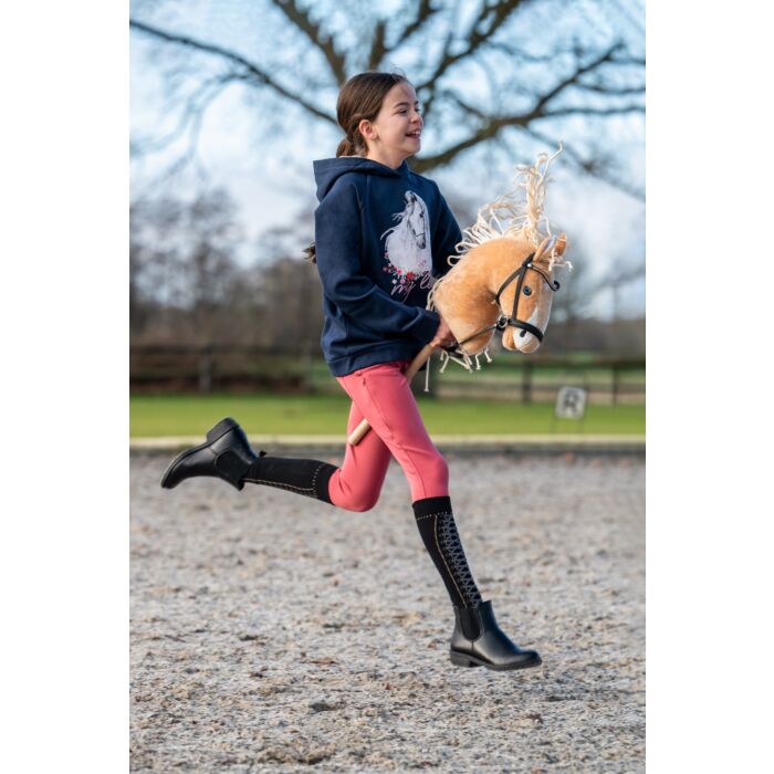 child playing with hobby horse